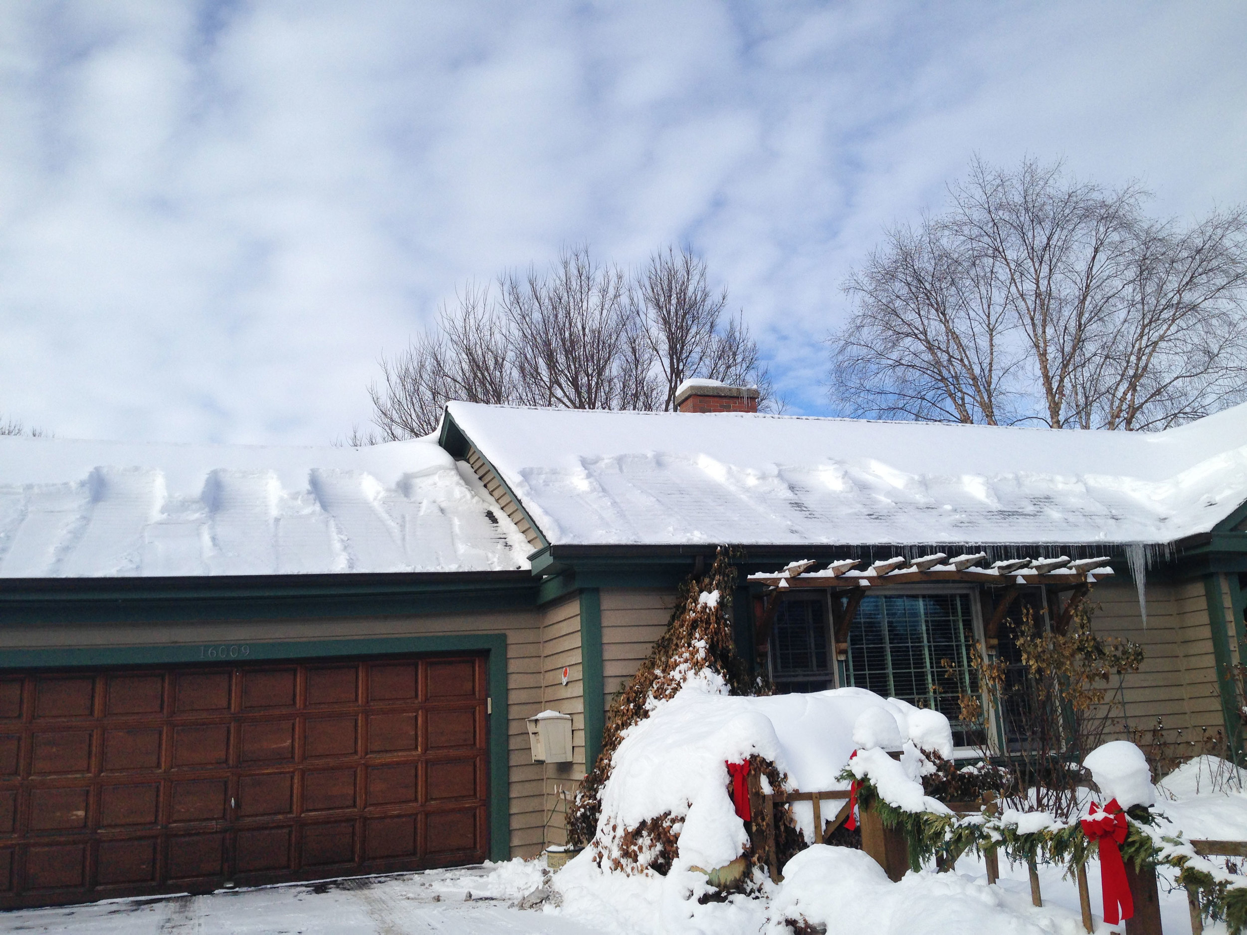 A recently “shoveled” roof, clearing the snow from the overhanging eaves and helping to prevent ice damming and interior water damage.