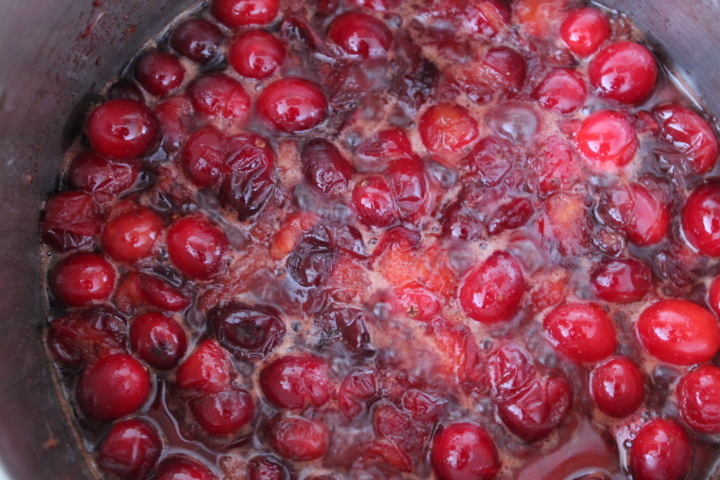 Cranberries cooking in a pot.