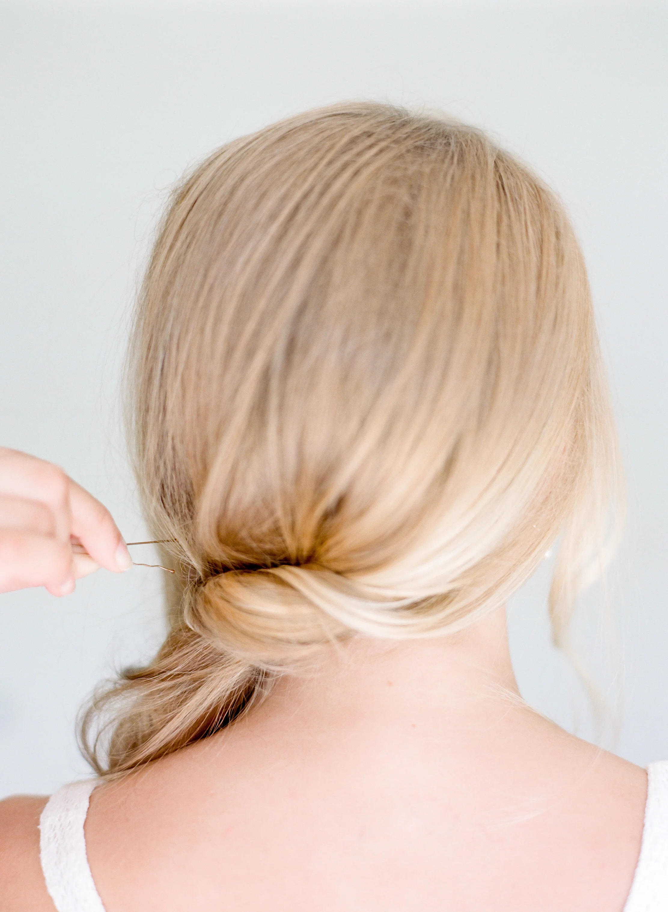 STEP TWO | Sweep hair to one side twisting from the bottom