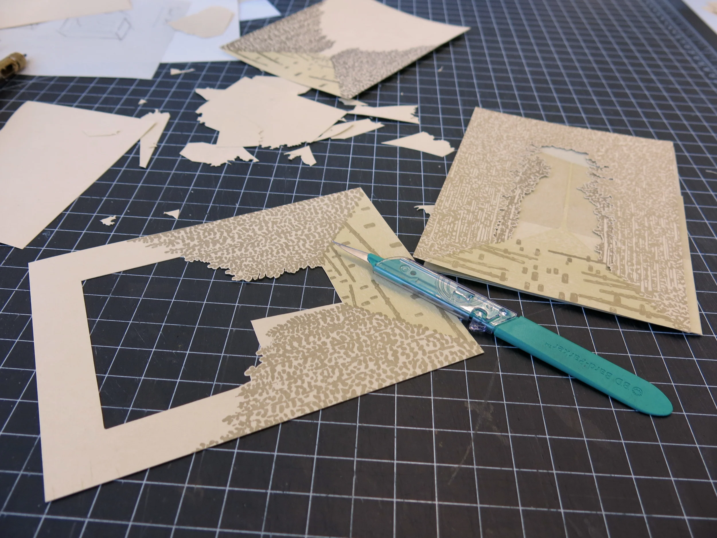 Letterpress printed panels in the process of being cut by hand.