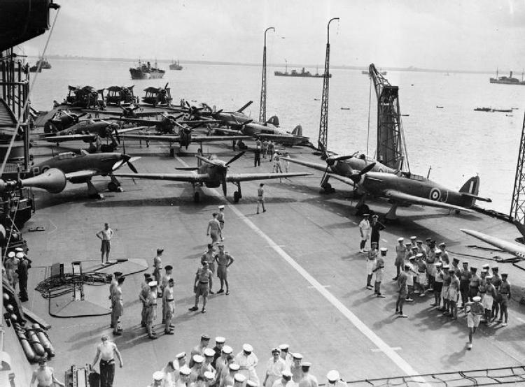 Hawker Sea Hurricanes and Fairey Albacores on the flight deck of HMS INDOMITABLE during a Malta convoy. Note the radio masts in the upright position and the crane on the edge of the deck.