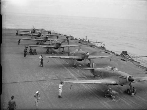 Six Hawker Sea Hurricanes of 885 Squadron, Fleet Air Arm with their engines running, ranged on the deck of HMS VICTORIOUS. All are ready to take off the moment an enemy aircraft is spotted.