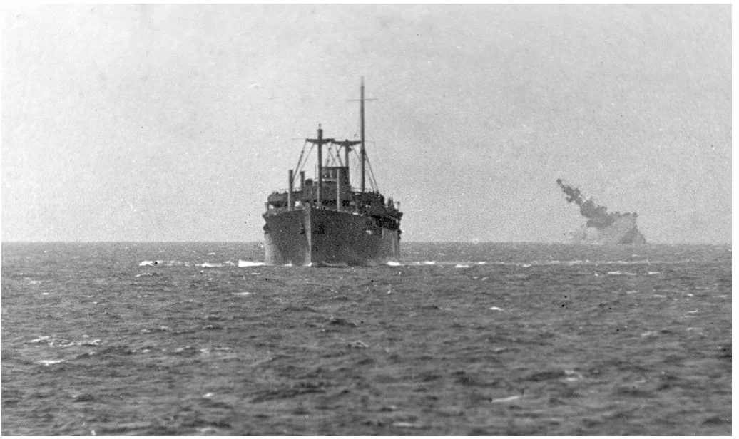 HMS EAGLE's flight deck is awash as a merchant ship from the Pedestal convoy presses on.