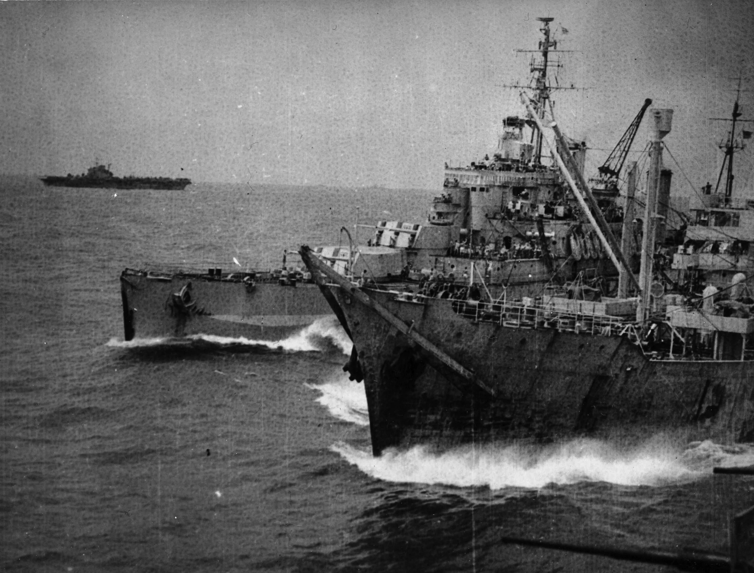 The oiler OLNA refuels HMS NEWFOUNDLAND with IMPLACABLE in the background.