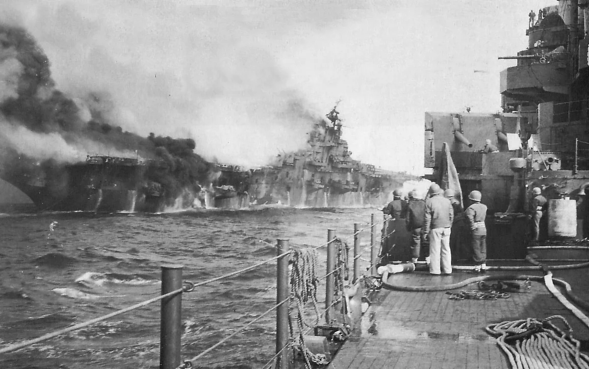 USS Franklin burns after being hit by one, and possibly a second partially detonated, 250kg (500lb) bomb.