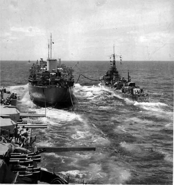 Royal Fleet Auxiliary Empire Salvage refuels HMS Whirlwind and HMS Illustrious. Note the unoccupied "outrigger" pylon between the Pom Pom mounts and the 4.5in turrets.