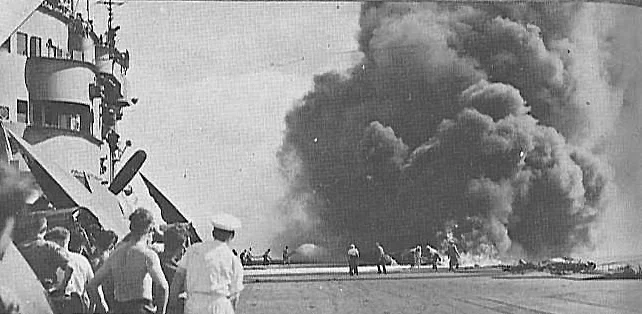 Firefighters tackle the blaze started by a kamikaze collision on HMS VICTORIOUS' aft flight deck. Also note VICTORIOUS' lack of ant-flash gear discipline in comparison to FORMIDABLE's crew.