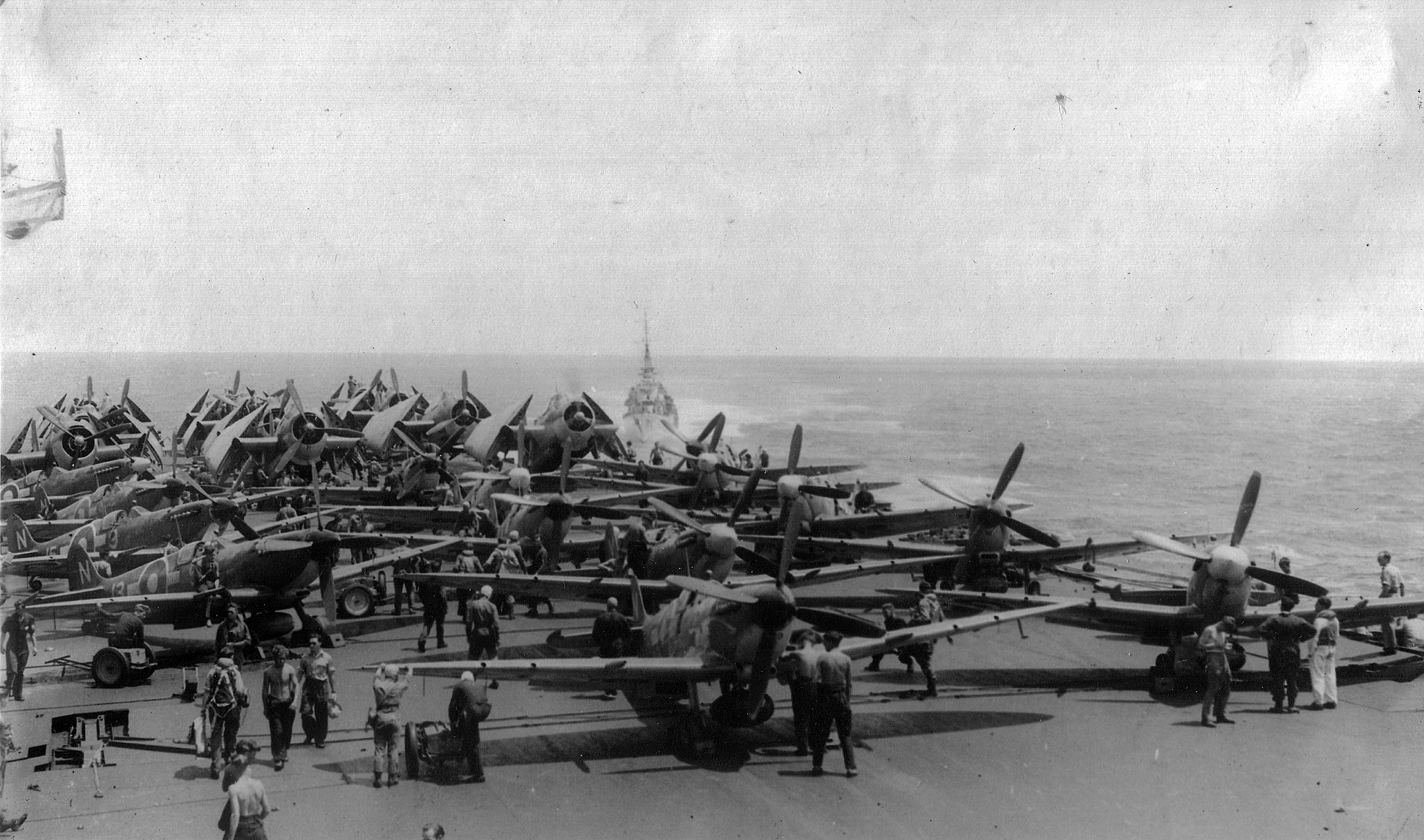 Seafires and Avengers are ranged for a strike aboard HMS IMPLACABLE. This carrier did not arrive until after the Sakishima campaign. Her Seafires can be identified by the large tear-drop drop tanks adapted from RAAF Kittyhawk stocks. HMS INDEFATIGABLE'S Seafires used the RAF's conformal "slipper" style.