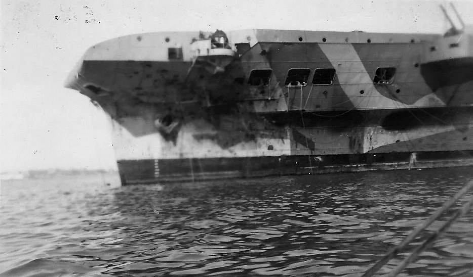 The scarred port bow of HMS ILLUSTRIOUS is seen in this picture believed to have been taken shortly after arriving in Alexandria.