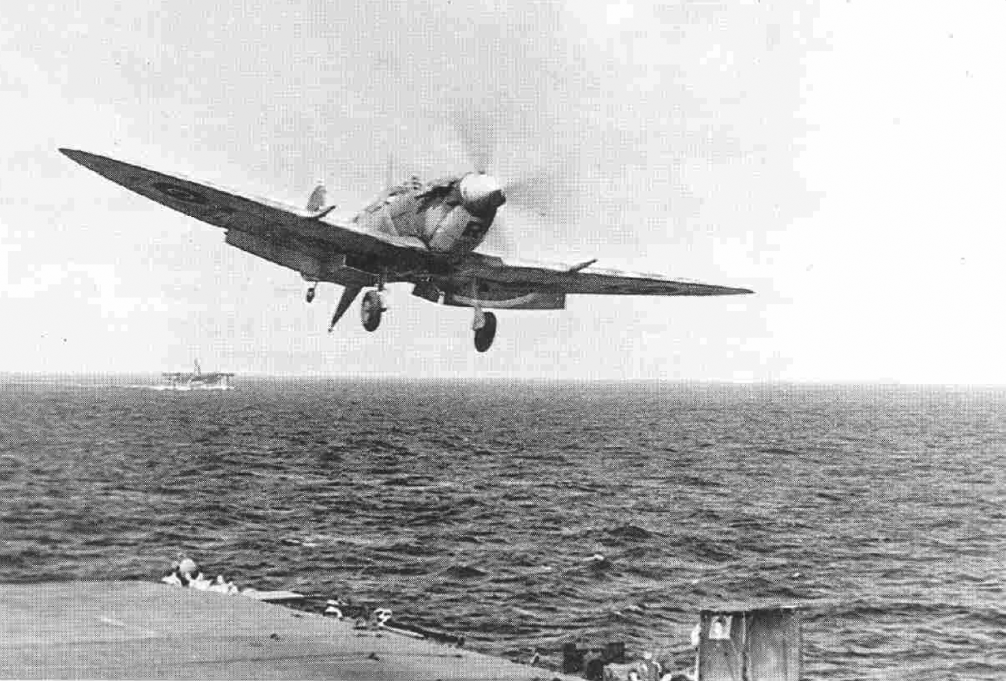 A Seafire goes around again after a failed approach on HMS HUNTER'S flight deck.