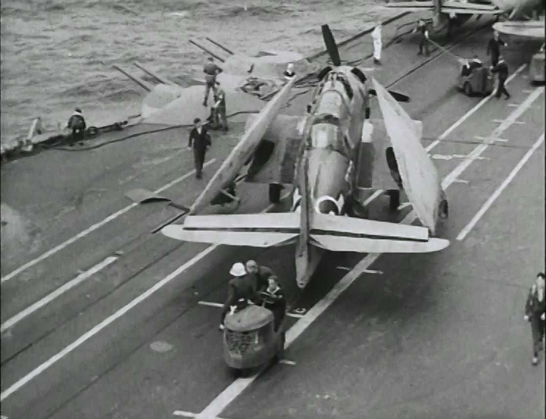 An Avenger is wheeled into the forward deck park, probably aboard HMS FORMIDABLE