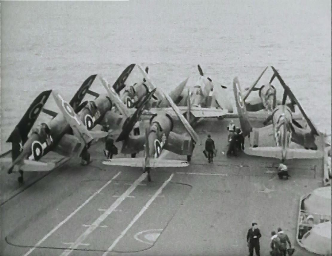 Corsairs and Avengers are stowed forward as a strike returns to the deck of HMS FORMIDABLE.