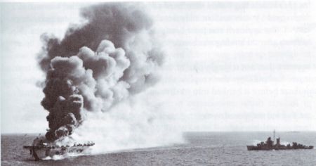 The escort carrier Ommaney Bay burns after being hit by a kamikaze.