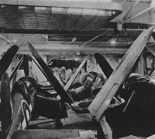 Corsairs in British Pacific Fleet markings sit inside HMS FORMIDABLE'S hangar. 