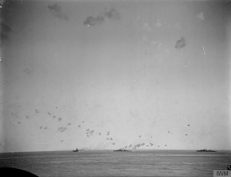 Two anti-aircraft cruisers join one of the armoured carriers, probably VICTORIOUS, in laying down a defensive barrage.