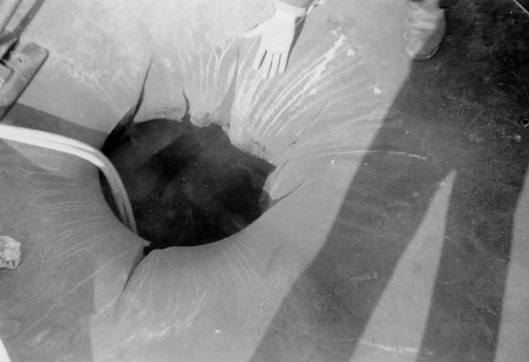 The entry hole left by the 2200lb (1000kg) bomb which pierced ILLUSTRIOUS's 3in 'box hangar' armour on the flight deck.