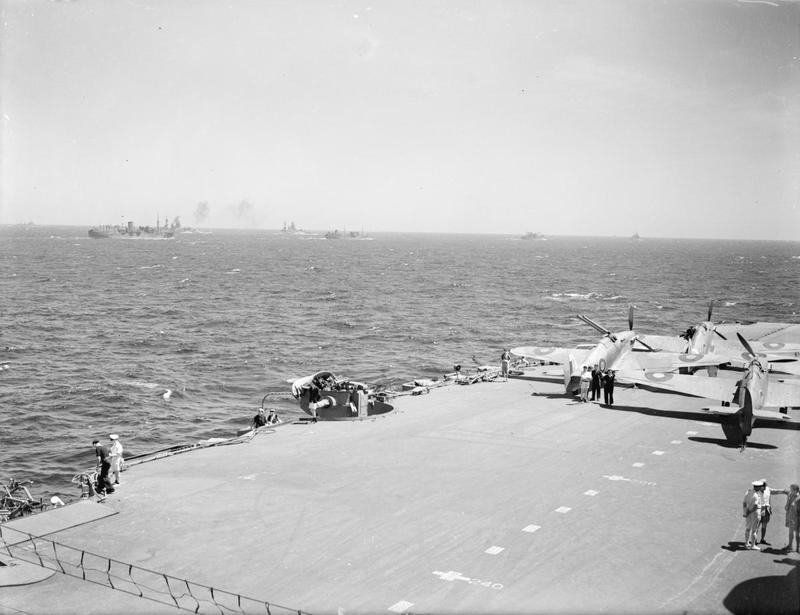 A deck park of Sea Hurricanes protected by the crash-barrier (foreground) aboard HMS INDOMITABLE.