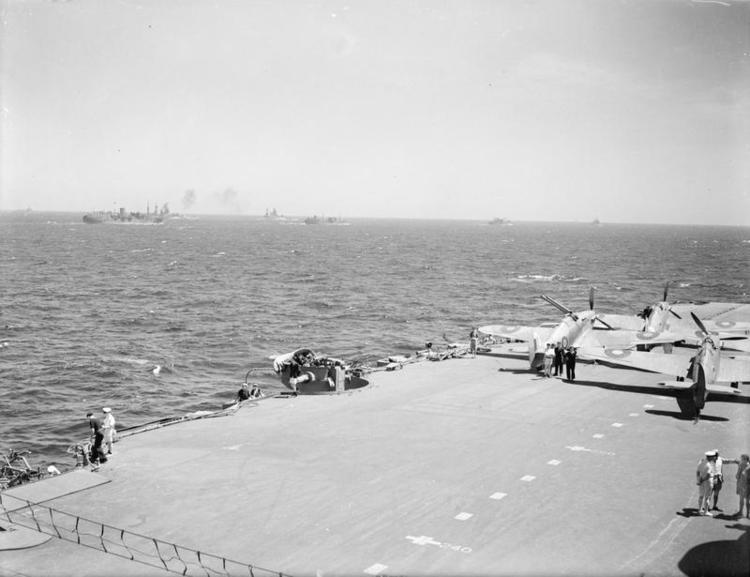 A deck park of Sea Hurricanes protected by the crash-barrier (foreground) aboard HMS INDOMITABLE.