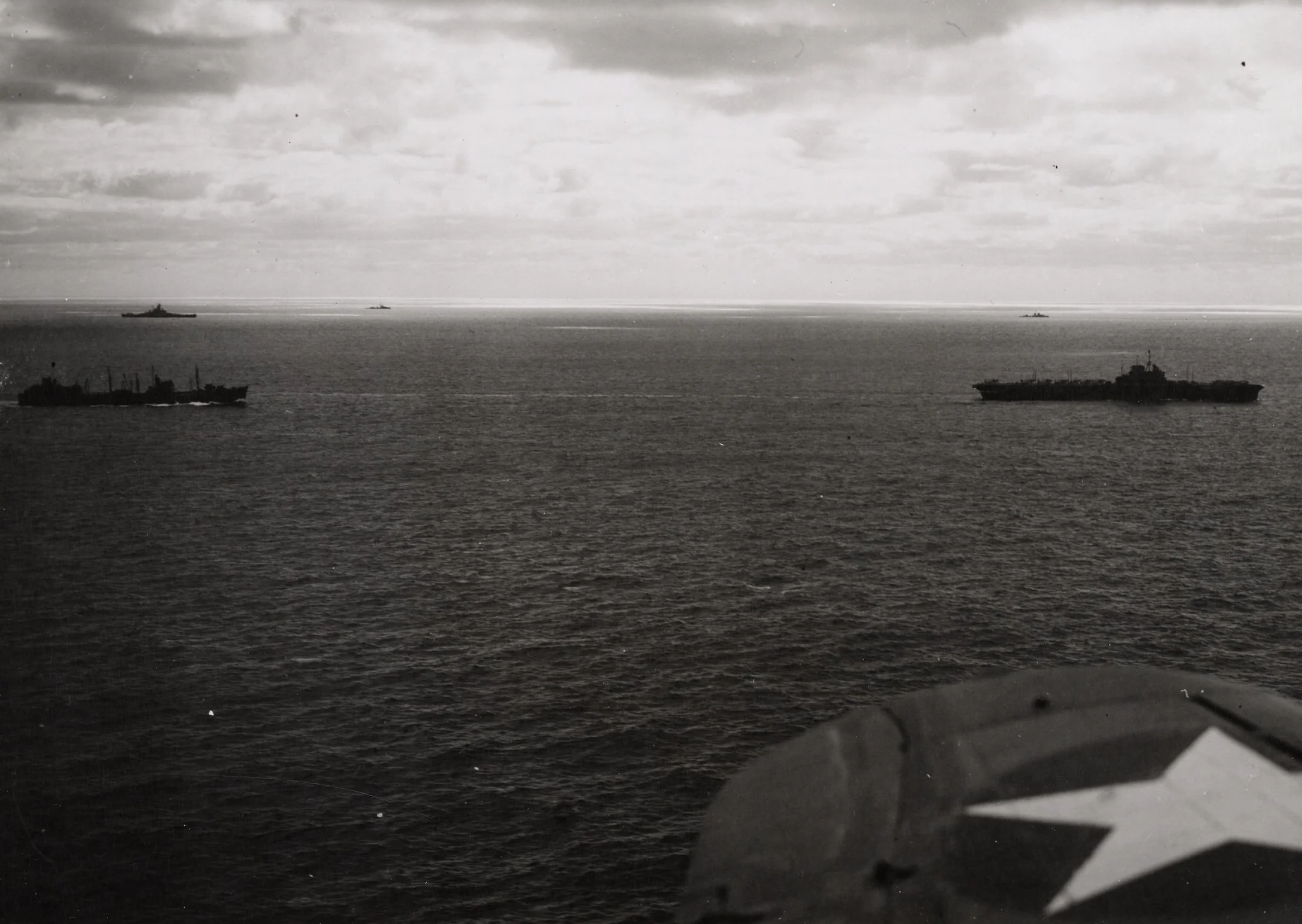 HMS VICTORIOUS at sea with the battleships, escort and supply ships of Task Force 14