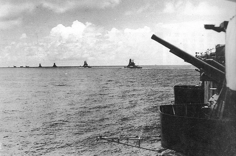 The carriers and battleships of the Japanese Indian Ocean strike force departing Starling Bay, marked as being taken on March 30. A translation of the original caption reads: March, 1942: the task force proceeding across the Indian Ocean: the view, from behind an anti-aircraft gun, front port side of the Zuikaku, shows the battle group in a single column, veering to port directly in front of he Zuikaku, with the carrier Akagi in the lead, followed by carriers Hiryu and Soryu, then battleships Hiei, Kirishima, Haruna and Kongo. The Shokaku is probably cruising to the rear of the Zuikaku