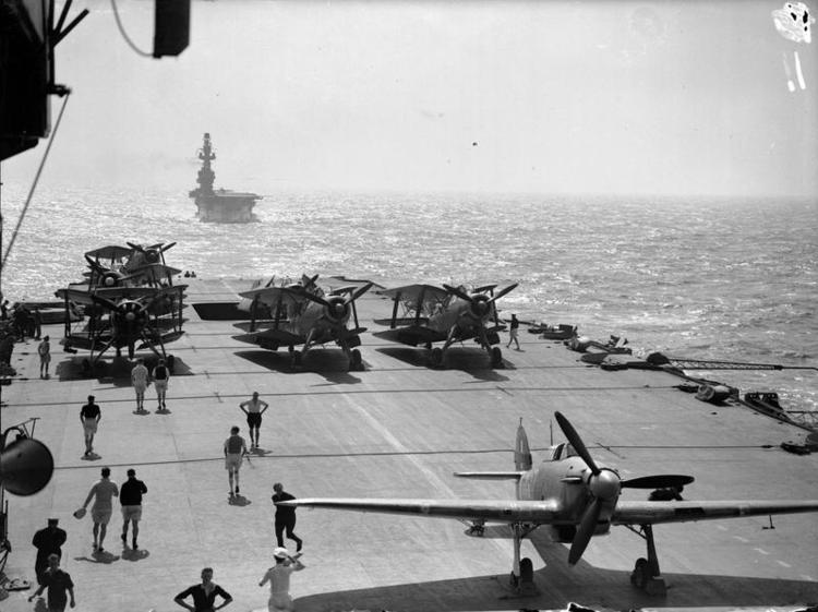 HMS EAGLE seen from the flight deck of HMS INDOMITABLE. Fairey Albacores and Hawker Hurricanes can be seen on the deck of INDOMITABLE, during a Malta convoy.