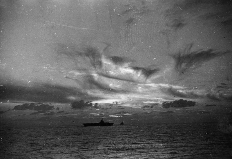 HMS ARK ROYAL at dusk in November 1940, from the deck of HMS SHEFFIELD.
