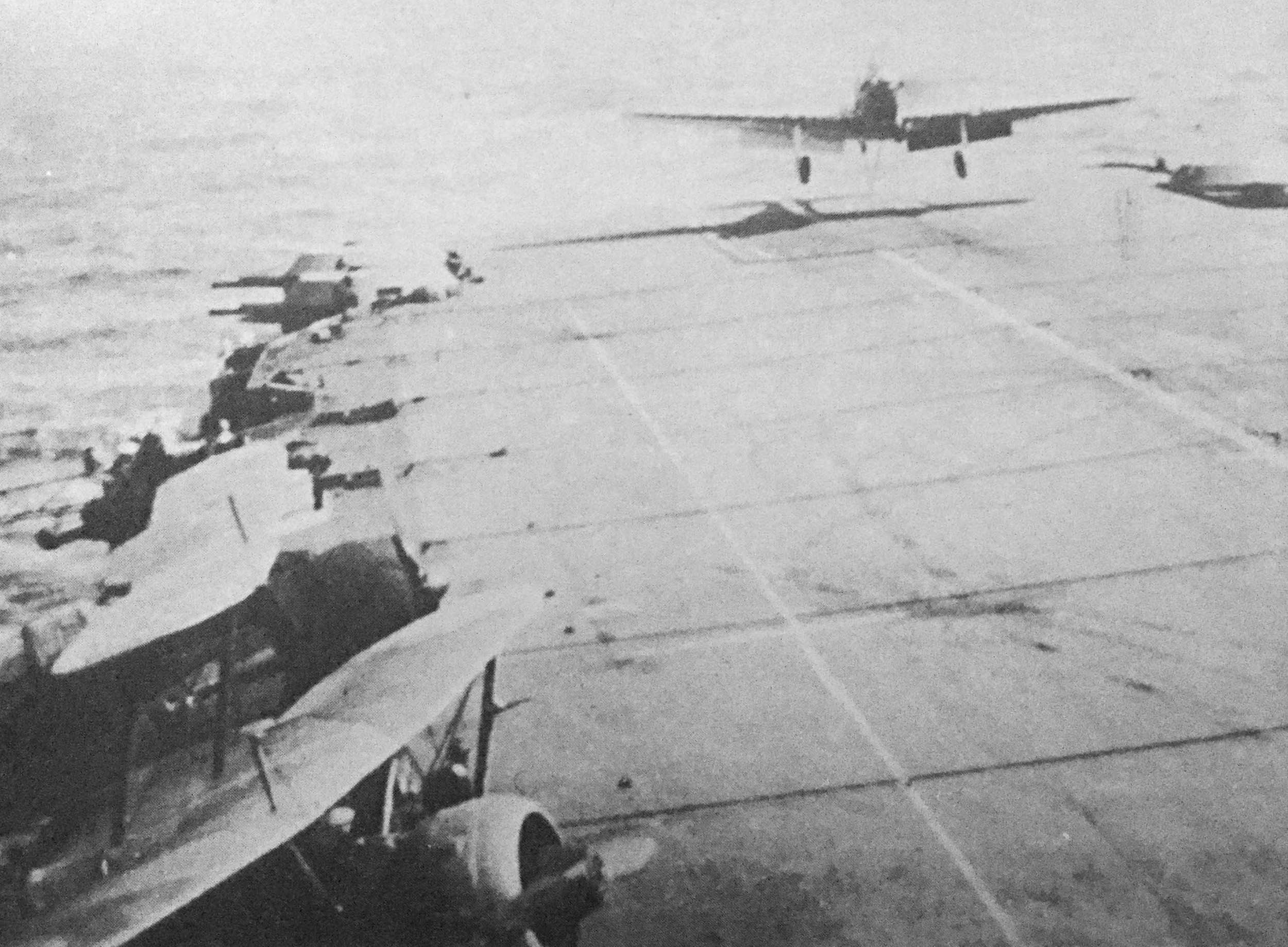 A poor quality but significant photograph as it shows two Sea Gladiators, bottom left, on outriggers while aboard HMS Illustrious during Operation Judgement. A Fulmar is about to touch-down.