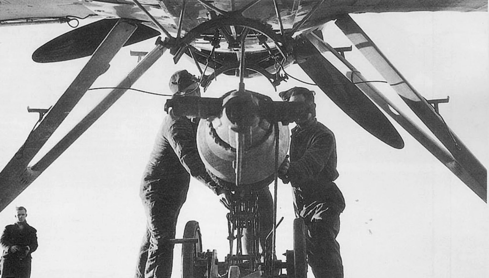 A torpedo is wheeled up to a Swordfish aboard HMS ILLUSTRIOUS