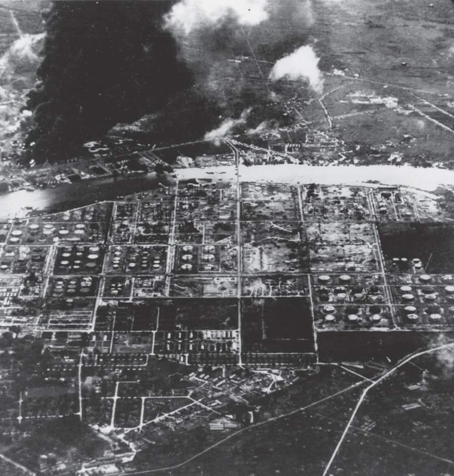 A post-strike photograph showing the fires spreading within Songei Gerong refinery. The damage caused days earlier to the Pladjoe refinery can be seen in the foreground.