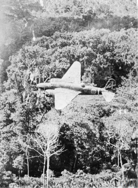 A Ki-21 Sally is pictured flying over dense jungle.