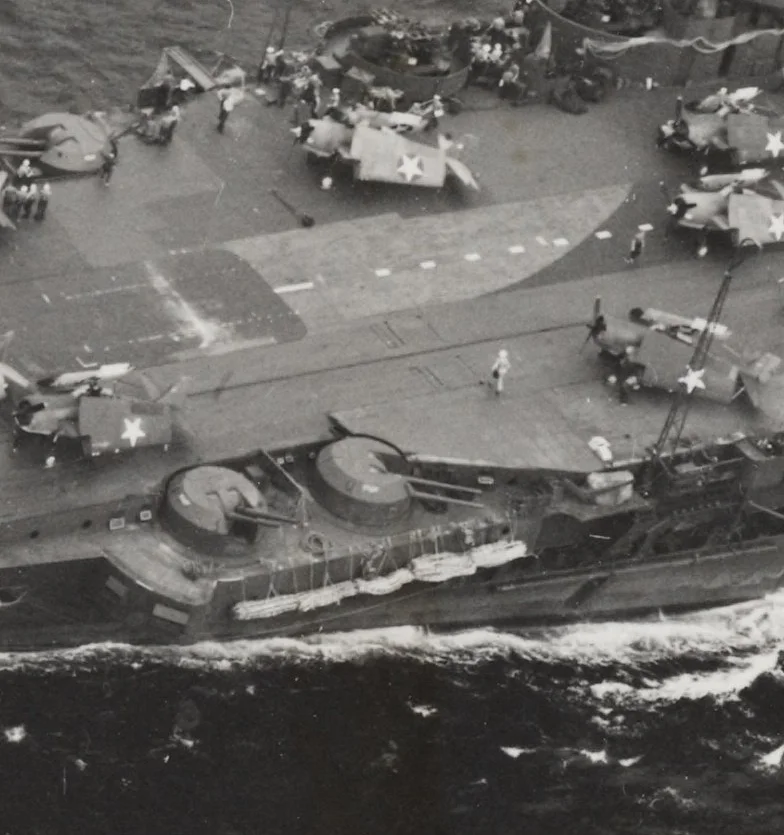 A close-up showing the bulged deck 'faring' placed about and behind B2 4.5in turret. This may have been to improve aircraft ranging around the accelerator and forward lift. Photos attributed to Operation Pedestal in August 1942 indicate this faring may have been in place before VICTORIOUS's sojourn as USS ROBIN.