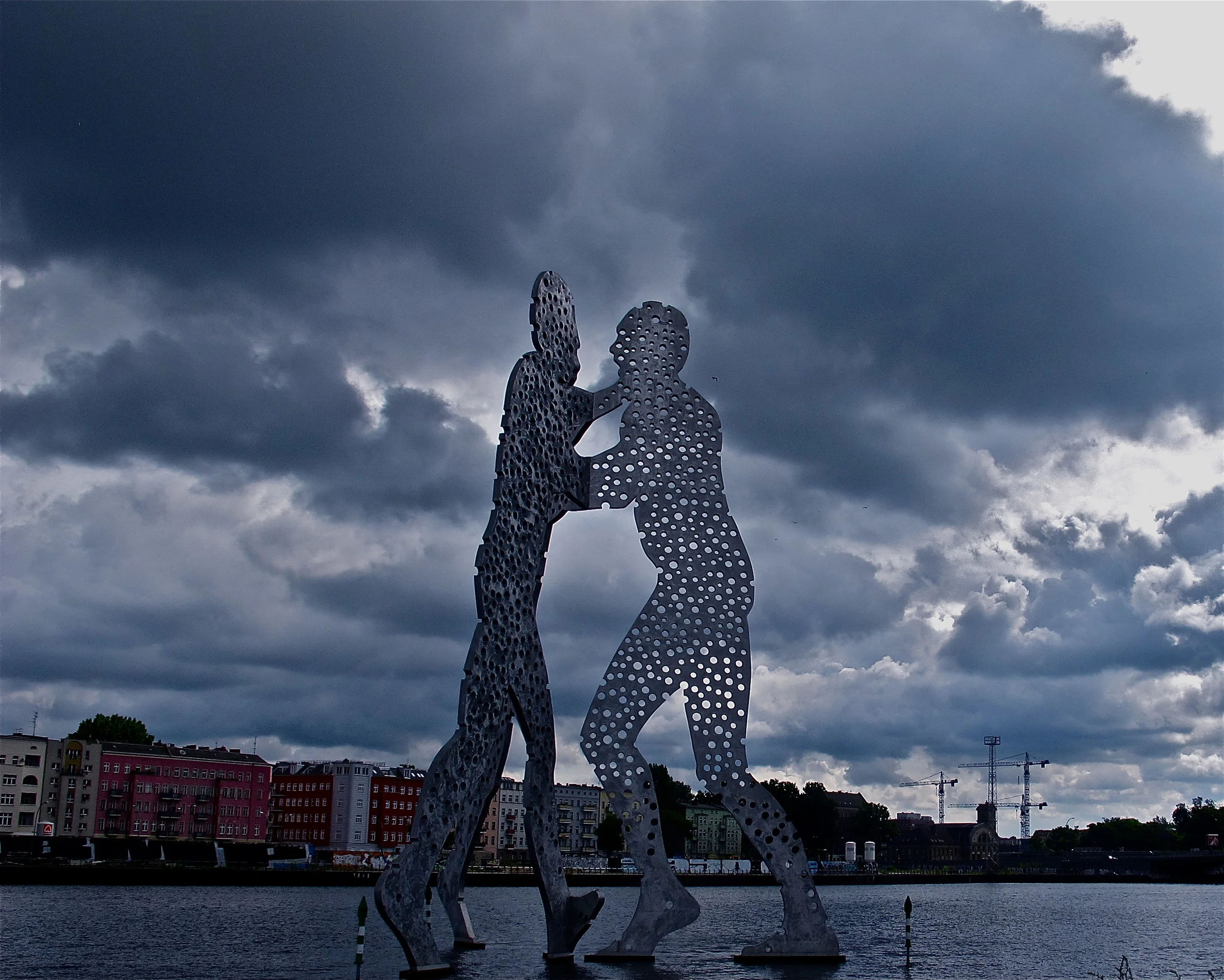 "MOLECULE MAN," BERLIN American sculptor Jonathan Borofsky placed these 90-feet high figures in the River Spree, in Berlin. The day I was there, the clouds added to the mood of huge men wrestling for control -- an illusion to East Berliny/West Berlin?