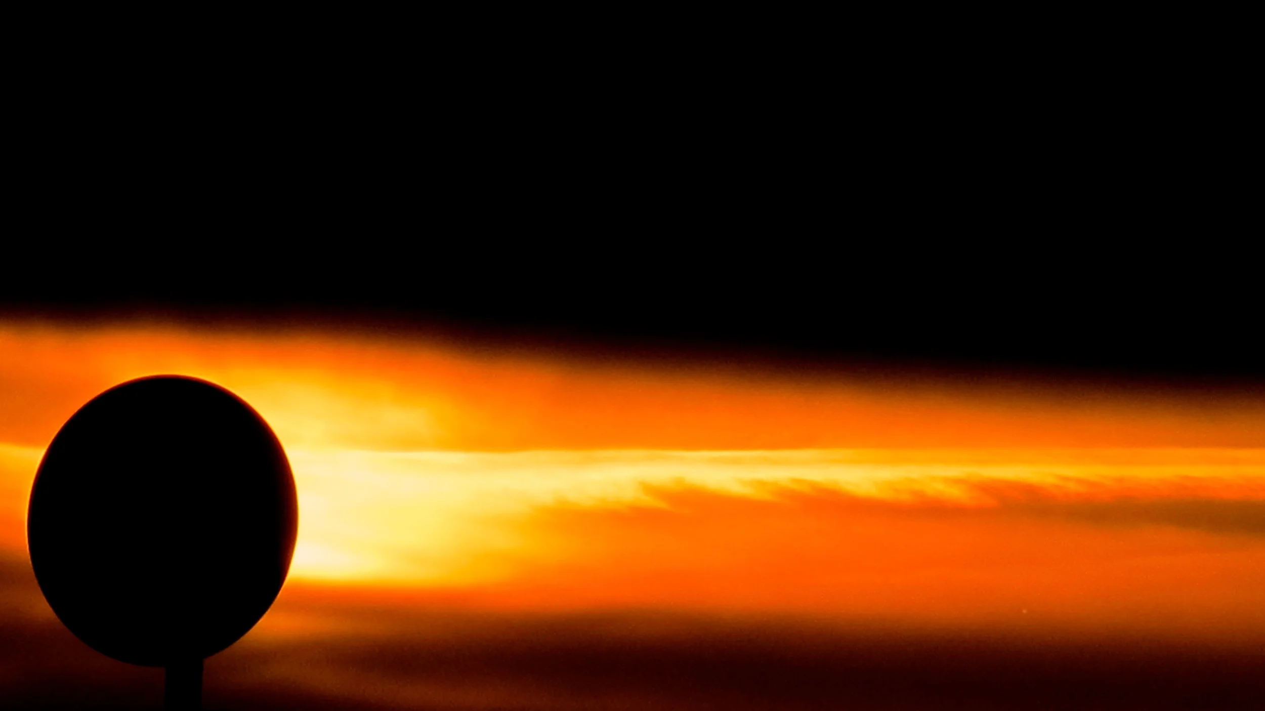 PLANETARY SUNRISE This could be a huge planet present at some extraordinary cosmological event, as captured by the Hubble Space Telescope in deep outer space. It was actually a dish on a neighbor's roof as the sun rose over San Francisco Bay. 