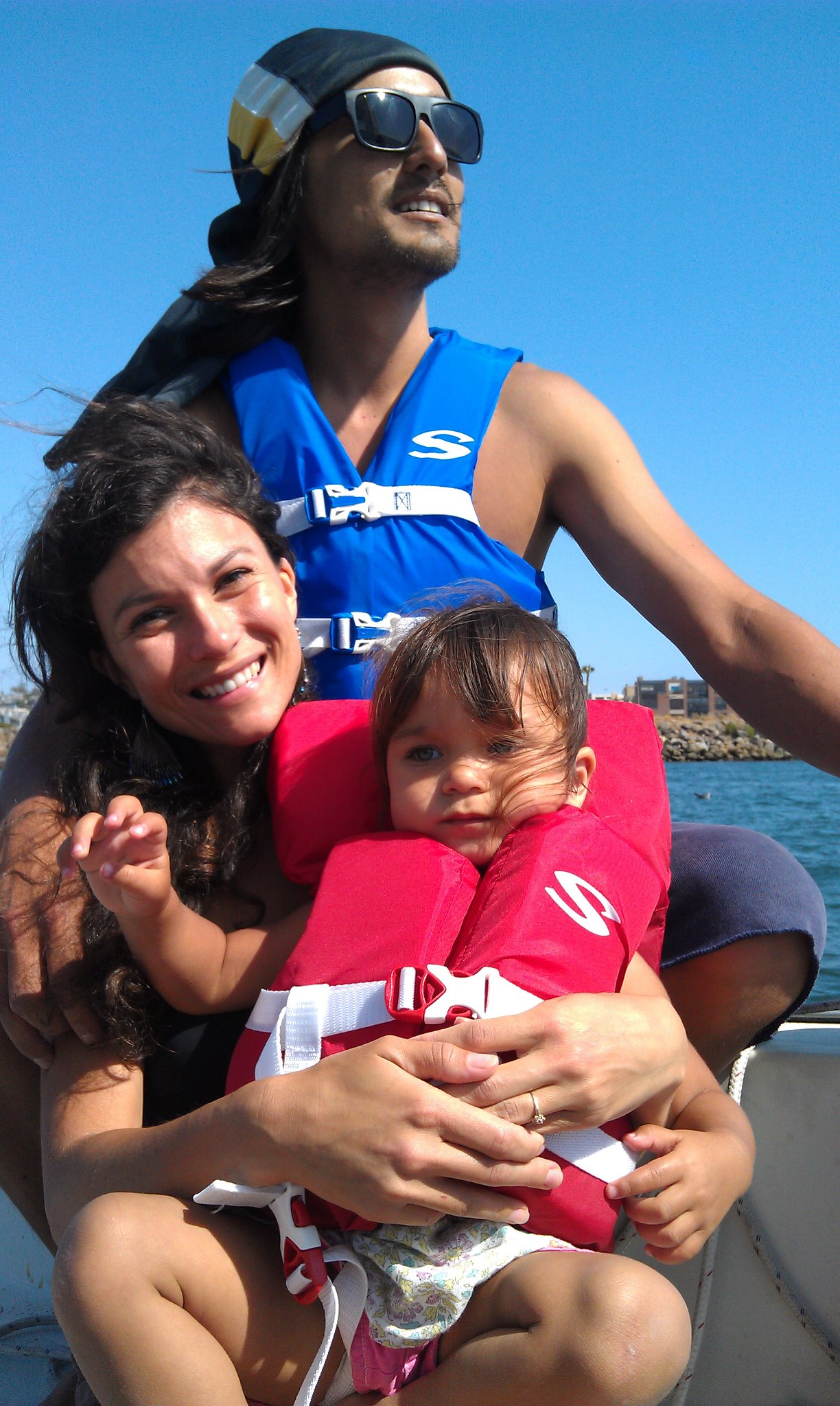 Captain Mitch, me, and Ava sailing on our boat.