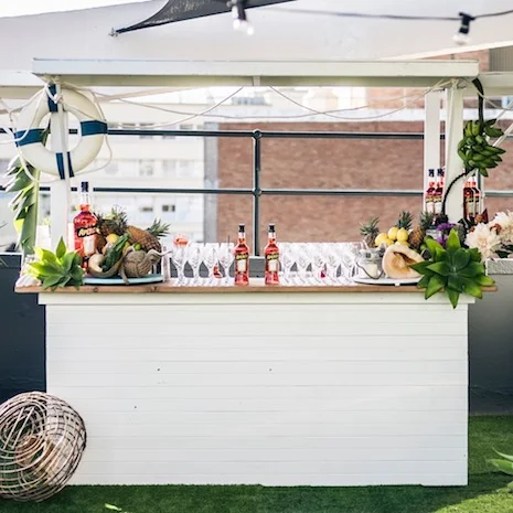 Hamptons Bar White wooden front and side with a timber bar top 3000mm (L) x 1800mm (W) x 2400mm (H) 2200mm (L) with roof sides lowered $500