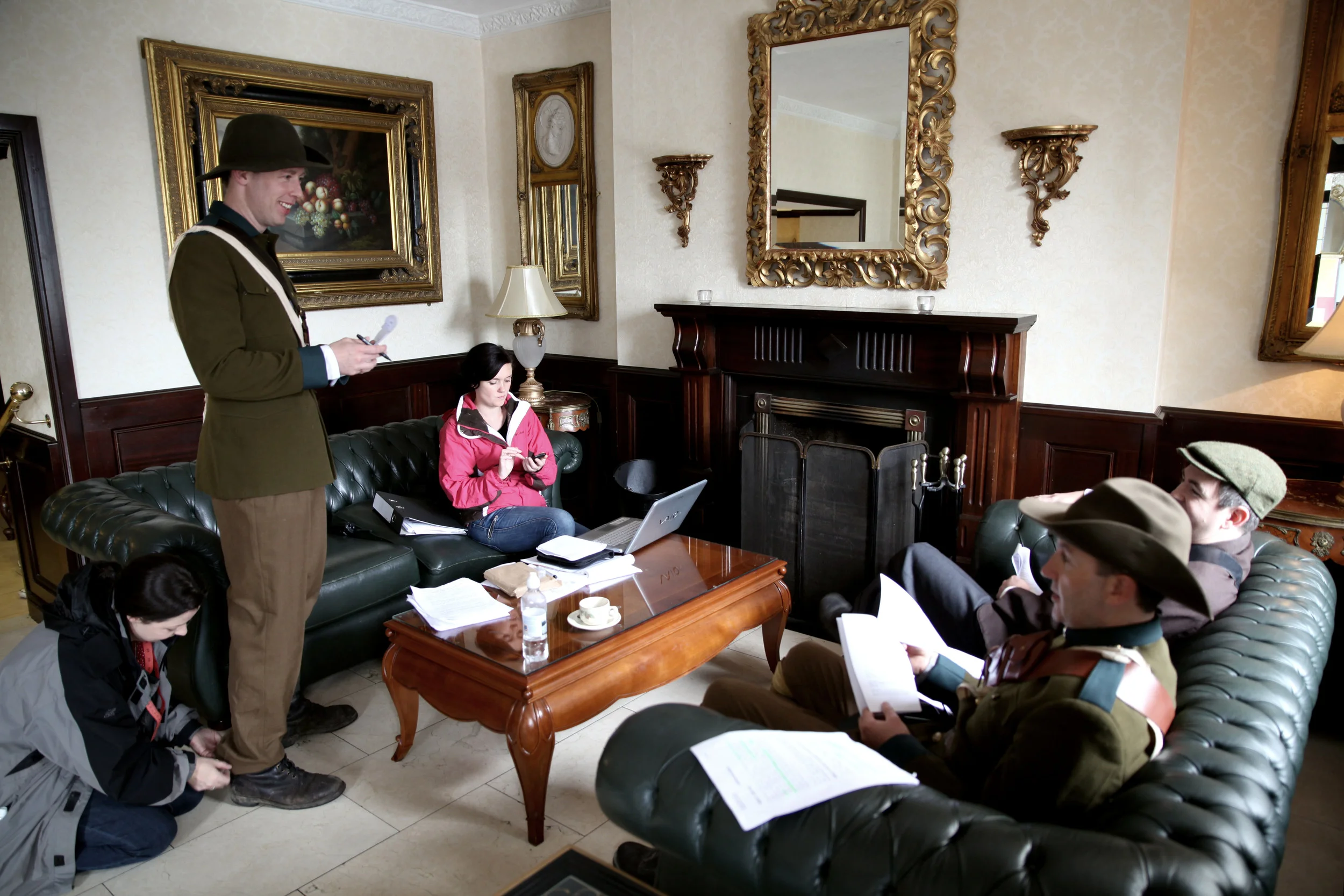 Production Manager Rebecca O'Malley and Irish Volunteers Seamus Hughes, Malachy McKenna and Cillian O'Donnachadha relax and learn their lines during a break in filming.