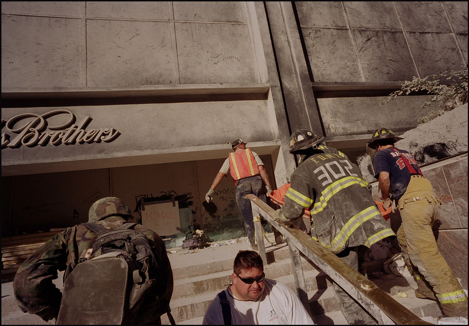 An army of rescue personnel carried bodies to a makeshift morgue past a message written in the dust— an eye for an eye.