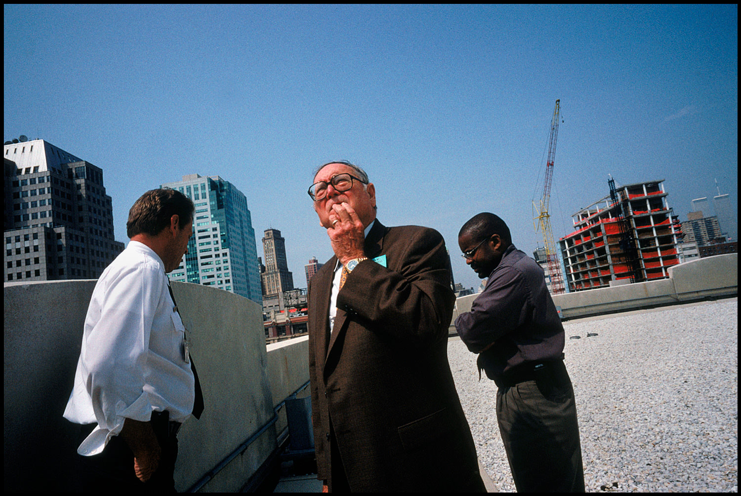 The twin towers standing behind him, Bill Patrick, former head of the U.S. Biological Weapons Program, surveys a New York City building for weakness to attack.