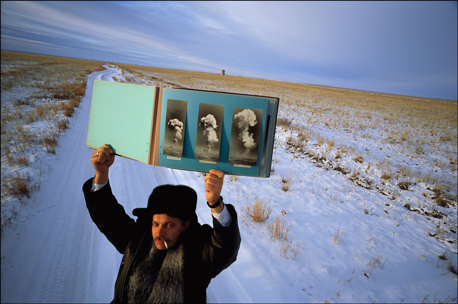 With pride, Vladimir Afonin, Security Chief, shows a book documenting Russian nuclear tests in Semipolitinsk, Kazakhstan. It is 30 degrees below zero.