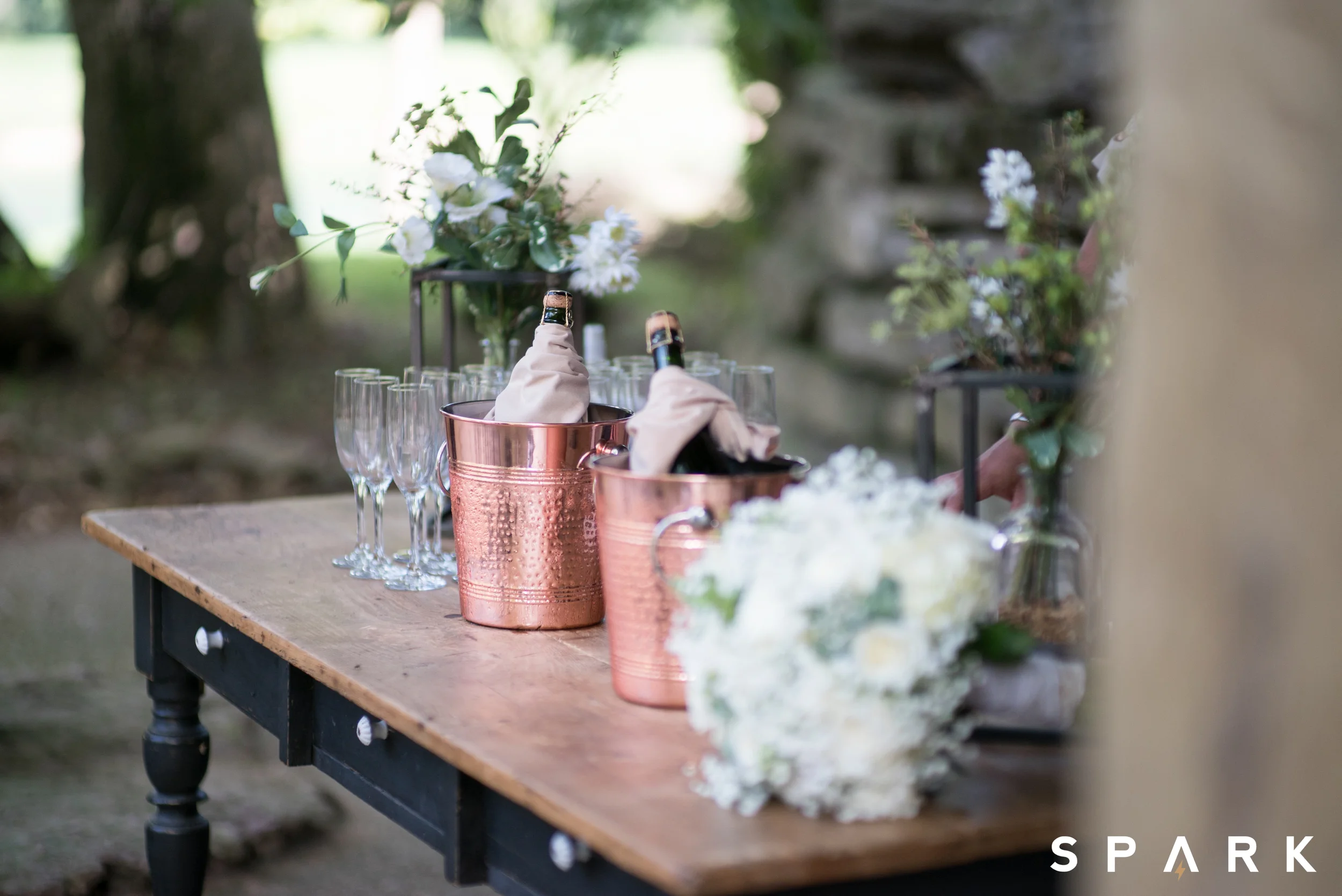 Pictured Above : Beautiful floral arrangements scattered the quaint venue while pops of copper accented the champagne station. 