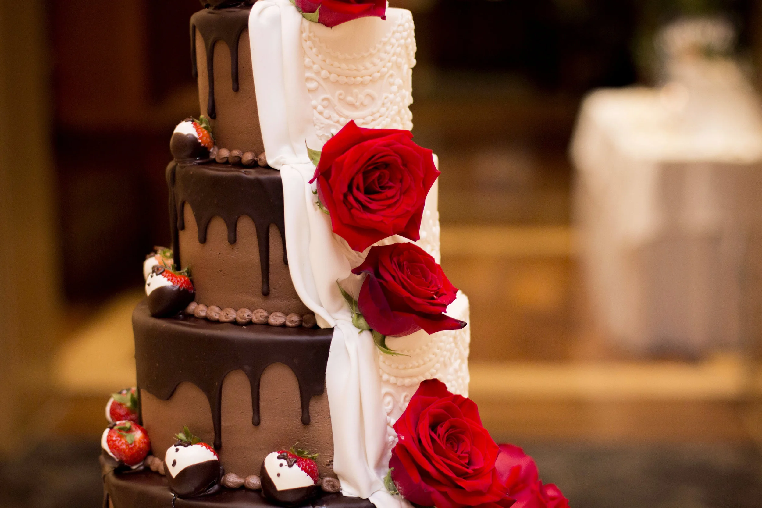ABOVE: Accented with tuxedo strawberries and red roses, it's no wonder why the cake was Ashley's favorite wedding detail. 