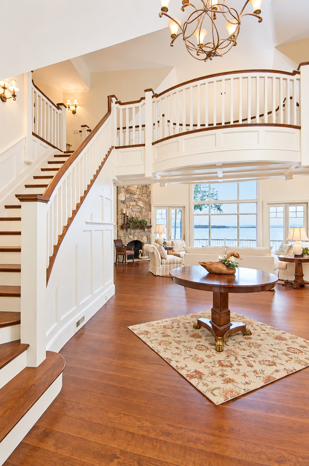 Elegant Curved Staircase Foyer with Lake View.png
