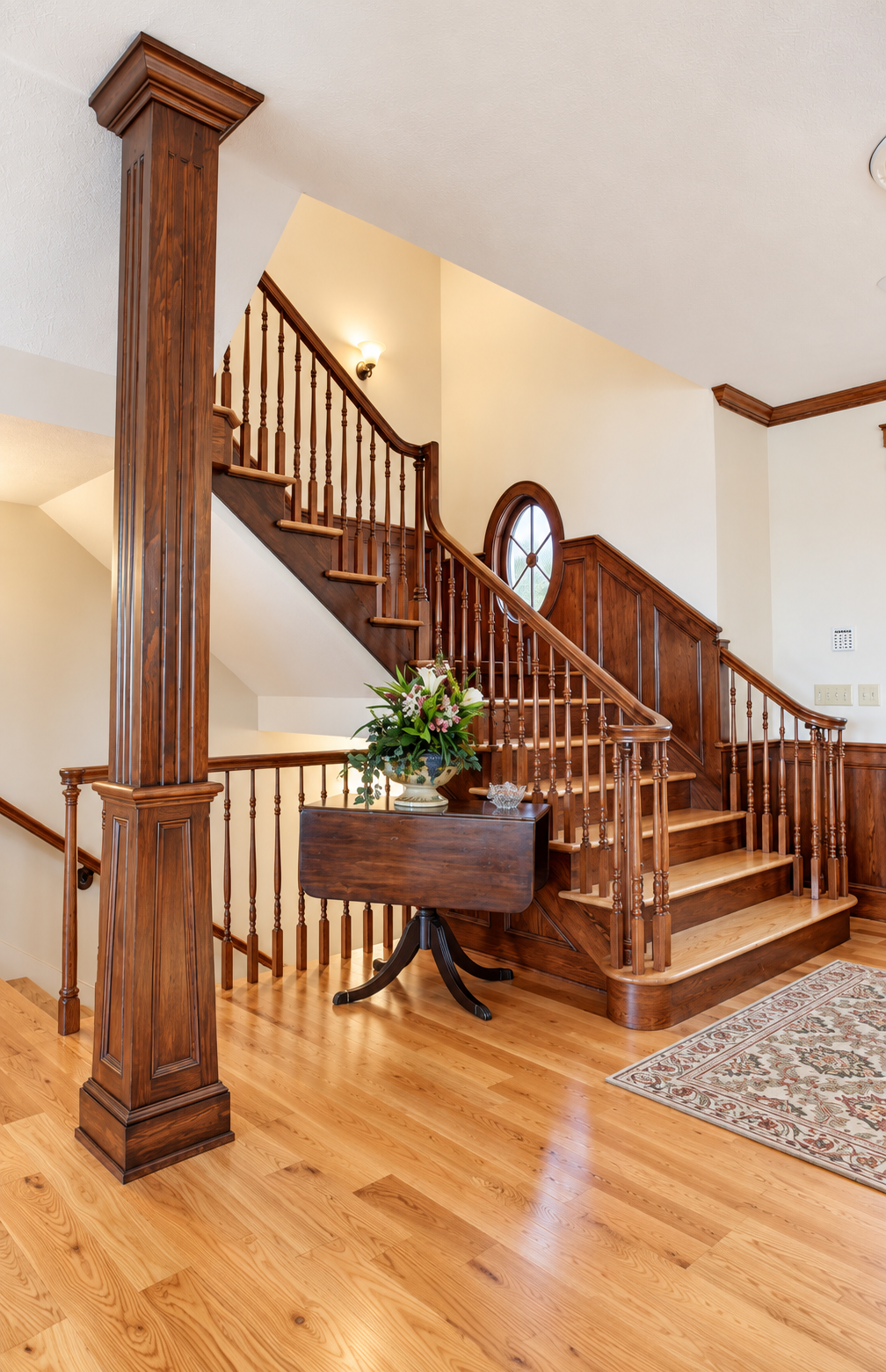 Warm Traditional Foyer with Oak Staircase.png