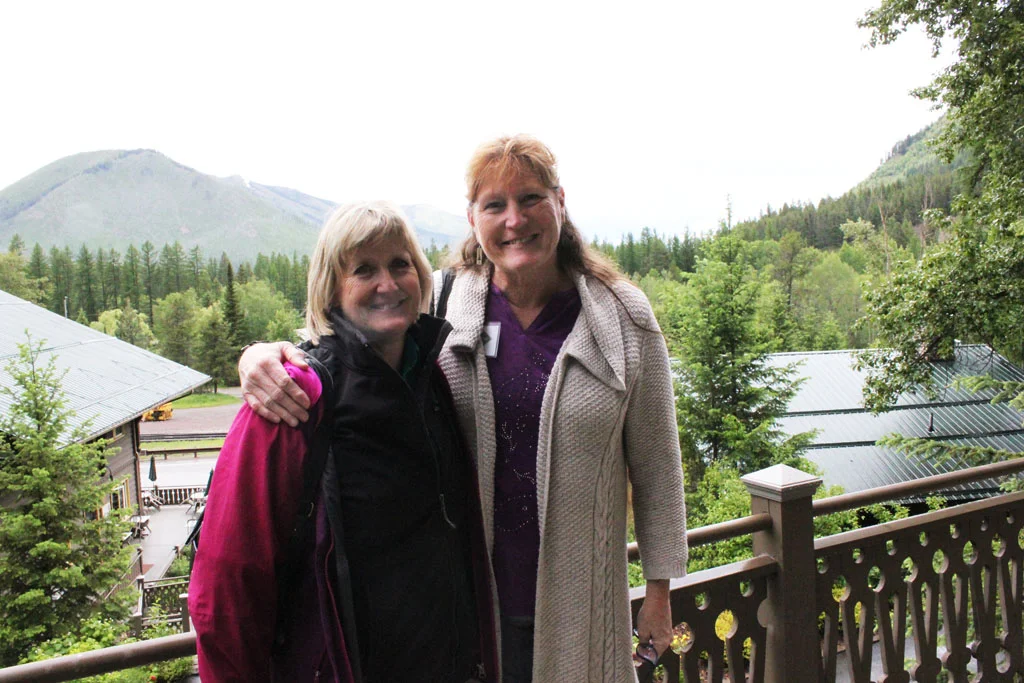 Enjoying the view at Belton. Charlene Porsild of the Montana History Foundation and Deb Mitchell of the Montana Historical Society on the balcony at Belton Chalet.