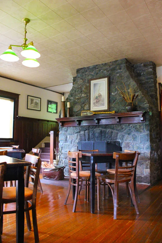 A spot by the cozy stone fireplace is a coveted seat during the cool Spring and Fall months.