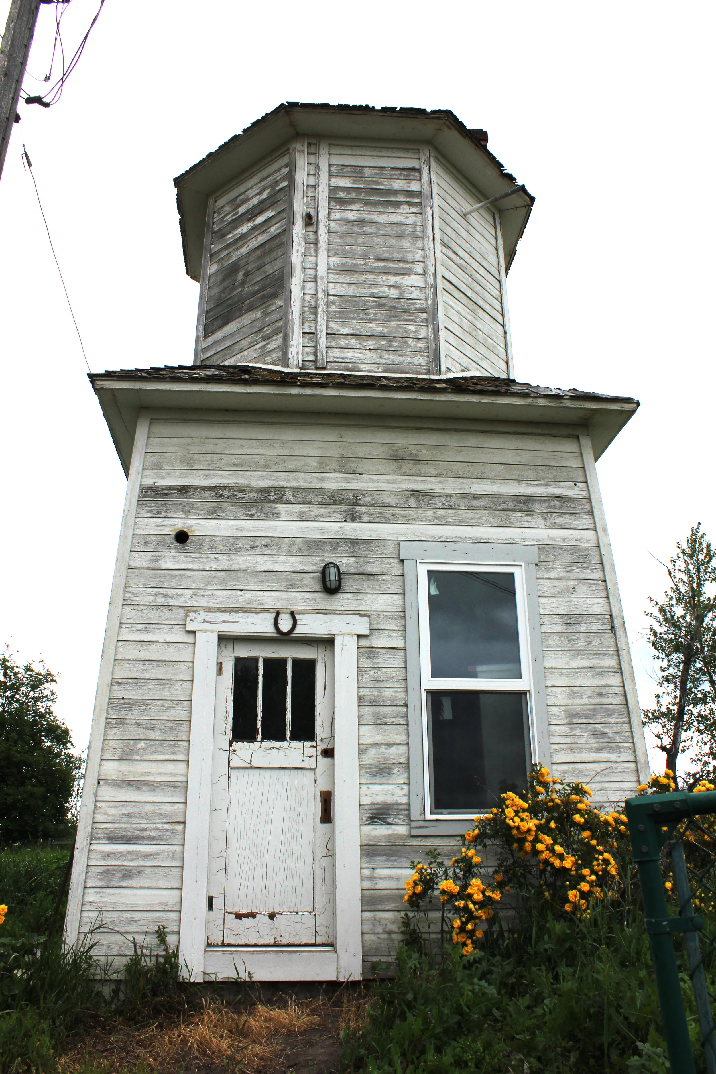 By 1907, the farm was prospering and the family added this water tank house, a luxury at the time, and also added a second story on the farmhouse. The tank house provided gravity powered running water for the kitchen by pulling water from a nearby windmill and storing it in an elevated zinc tank in the upper portion of the tower. Below, a water trough kept dairy products cool, and in the winter a stove ran to keep the water from freezing.