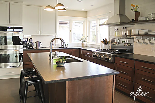 The kitchen cabinetry features the same quarter-sawn oak and painted white cabinets but in a shaker door style.