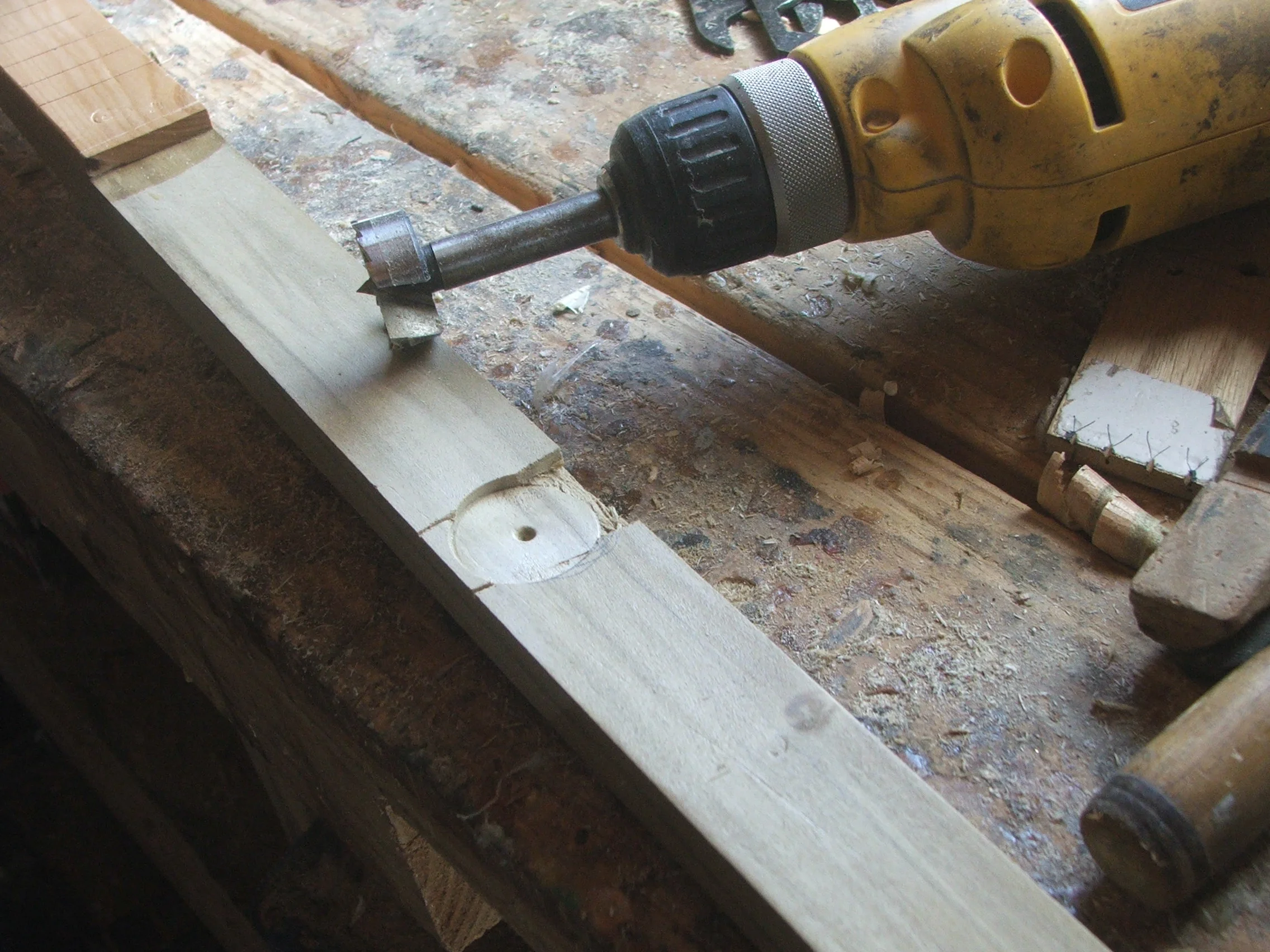 Use forsner bit to hollow out space where neck piece will fit over glued up pick-up so neck fits flat to box