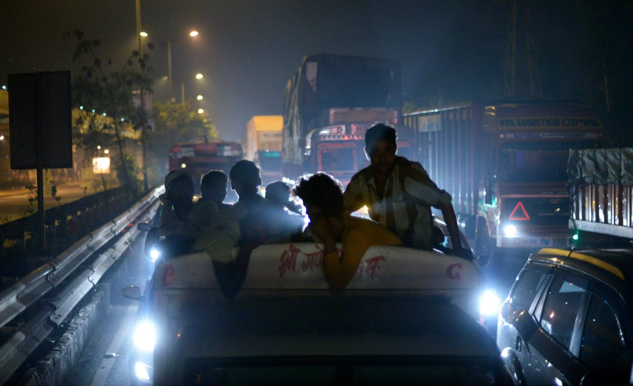Taken from the back window of a bus making its way through midnight traffic in New Delhi. 
