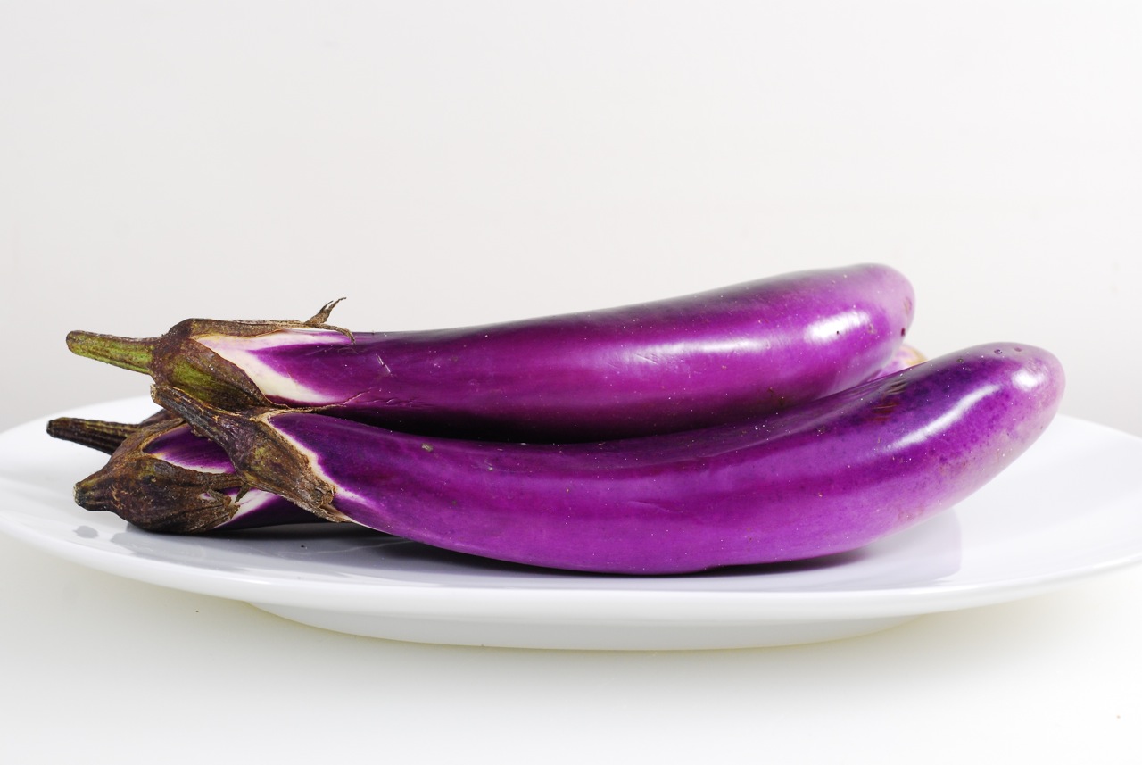 Japanese Eggplant - Similar to regular eggplant but with a fun shape. Slice it cross ways or long ways, toss with olive oil, season with salt and pepper and fry or grill it until soft. Add garlic or other seasonings for additional flavor. Note that eggplant will soak up liquids at first but when salt is added it will release its liquid.